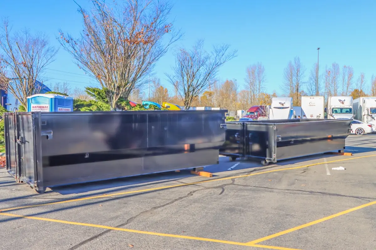 Professional dumpster rental service with roll-off container on residential driveway in Bull Run